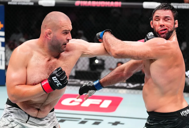 Martin Buday lands a heavy left punch on his opponent during a UFC fight. The text highlights his recent form and career stats, listing wins over Chris Barnett, Josh Parisian, Andrei Arlovski, Uran Satybaldiev, and Marcus Buchecha.
